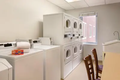 a laundry room with white washers and dryers at Residence Inn Denver City Center in Denver
