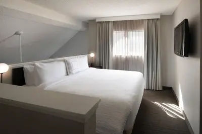 a hotel room with a white bed and a window at Residence Inn by Marriott Boulder in Boulder