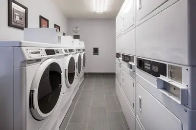 a laundry room with white washing machines and cabinets at Residence Inn by Marriott Boulder in Boulder