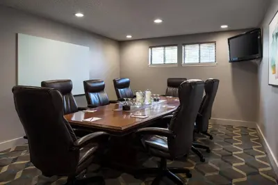 a conference room with a wooden table and black chairs at Residence Inn by Marriott Boulder in Boulder