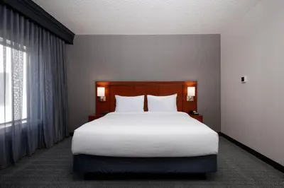 a bedroom with a large white bed and a window at Courtyard Denver Tech Center in Greenwood Village