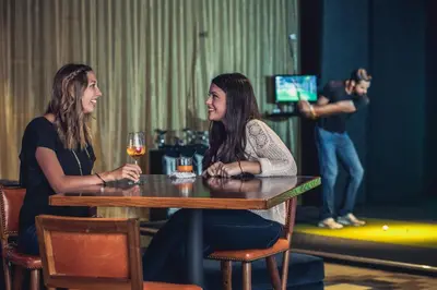 two women sitting at a table with a glass of wine at Courtyard Denver Tech Center in Greenwood Village
