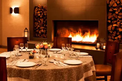 a table in a restaurant with a fireplace at Denver Marriott West in Golden