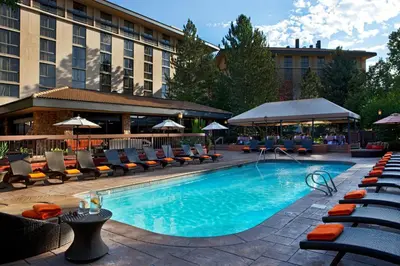 a swimming pool with lounge chairs and a hotel at Denver Marriott West in Golden