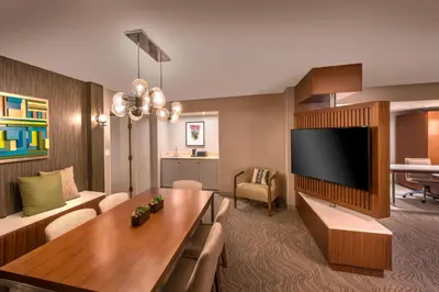 a living room with a couch and a tv at Denver Marriott Tech Center in Greenwood Village