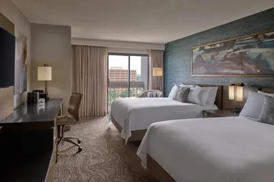 a hotel room with two beds and a desk and a window at Denver Marriott Tech Center in Greenwood Village