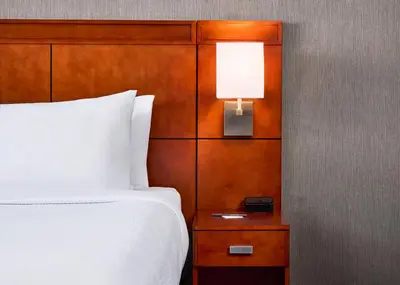 a bedroom with a bed and a lamp on a night stand at Courtyard by Marriott Fort Collins in Fort Collins