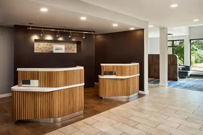 a lobby with two reception desks in a building at Courtyard by Marriott Fort Collins in Fort Collins