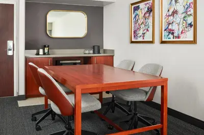a conference room with a wooden table and chairs at Courtyard by Marriott Fort Collins in Fort Collins