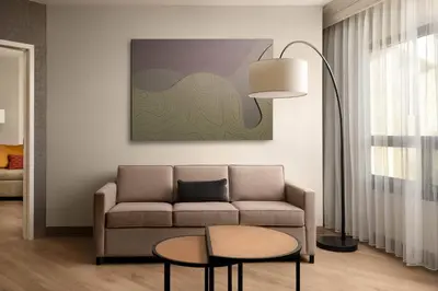 a living room with a couch and a table at Fort Collins Marriott in Fort Collins