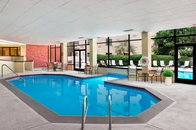 a pool with blue water in a building at Fort Collins Marriott in Fort Collins