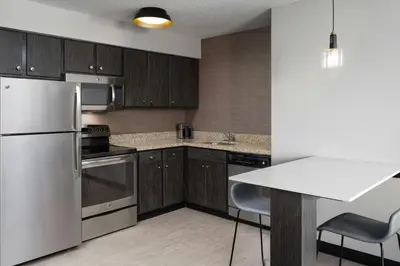 a kitchen with stainless steel appliances and wooden cabinets at Residence Inn by Marriott Fort Collins in Fort Collins