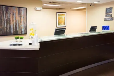 an office with a reception desk with two chairs at Residence Inn by Marriott Fort Collins in Fort Collins