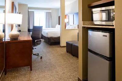 a hotel room with a desk and a bed at Comfort Suites Denver near Anschutz Medical Campus in Aurora