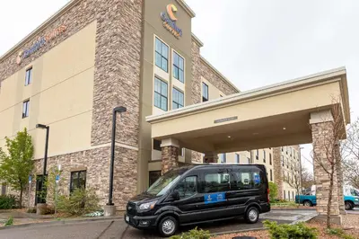 a black van parked in front of a building at Comfort Suites Denver near Anschutz Medical Campus in Aurora