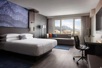 a bedroom with a bed and a desk and a chair at Boulder Marriott in Boulder