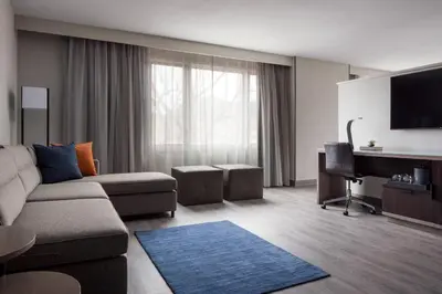 a living room with a couch and a flat screen tv at Boulder Marriott in Boulder
