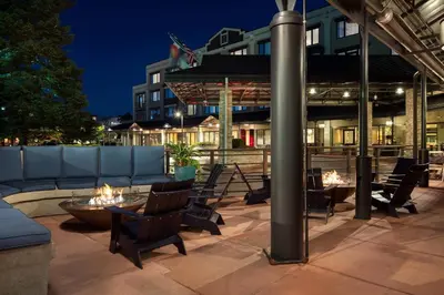 a patio with chairs and a fire pit at night at Boulder Marriott in Boulder