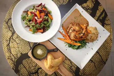 a plate of food with a salad and a bowl of dips at Boulder Marriott in Boulder