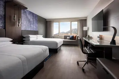 a hotel room with two beds and a desk at Boulder Marriott in Boulder