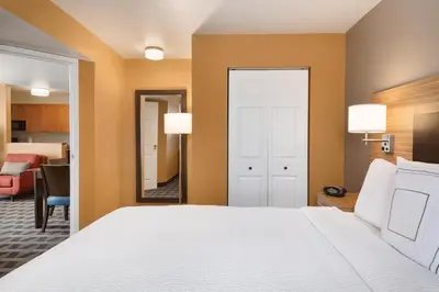 a bedroom with a bed and a living room at TownePlace Suites by Marriott Denver Downtown in Denver