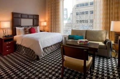 a hotel room with a bed and a couch at Courtyard by Marriott Denver Downtown in Denver