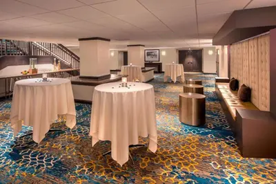 a room with two tables and chairs and stairs at Courtyard by Marriott Denver Downtown in Denver