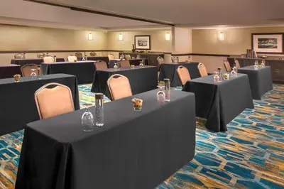 a conference room with black tables and chairs at Courtyard by Marriott Denver Downtown in Denver