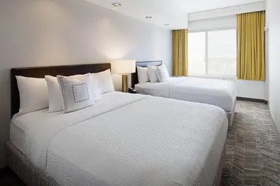 a hotel room with two beds and a window at SpringHill Suites by Marriott Denver Airport in Denver