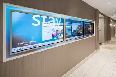 a large television on a wall in a hallway at SpringHill Suites by Marriott Denver Airport in Denver