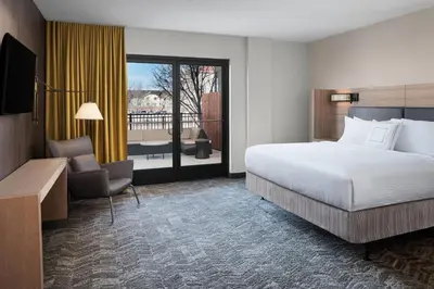 a hotel room with a bed and a balcony at SpringHill Suites by Marriott Denver Airport in Denver