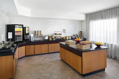 a lobby of a hotel with a breakfast buffet at Fairfield Inn & Suites Denver Airport in Denver