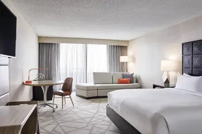 a hotel room with a bed and a couch at Renaissance Denver Hotel & Conference Center in Denver
