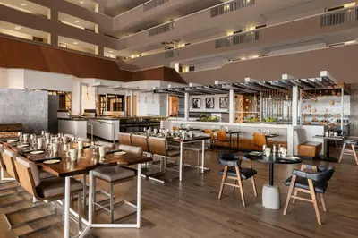 a restaurant with tables and chairs and a bar at Renaissance Denver Hotel & Conference Center in Denver