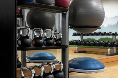 a room with a rack of dumbbells and a mirror at Renaissance Denver Hotel & Conference Center in Denver