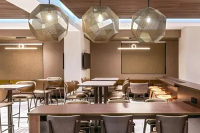 a dining room with tables and chairs and a chalkboard at SpringHill Suites Denver North / Westminster in Westminster