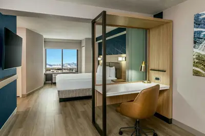 a hotel room with a bed and a desk with a chair at SpringHill Suites Denver North / Westminster in Westminster