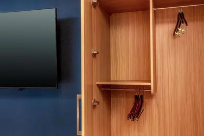 a wooden cabinet with a tv and some umbrellas at SpringHill Suites Denver North / Westminster in Westminster
