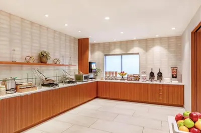 a large kitchen with a counter and a window at SpringHill Suites Denver North / Westminster in Westminster
