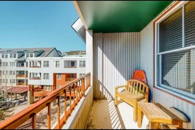 a balcony with a bench and a view of a city at River Run Village 1 Bedroom Condo in Keystone
