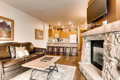 a living room with a couch and a fireplace at River Run Village 1 Bedroom Condo in Keystone