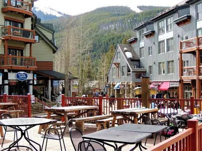 a group of tables and chairs in a town with buildings at River Run Village 2 Bedroom Condo - 100 Yards To Slopes, Pool, Hot Tub Access in Keystone