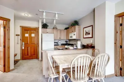 a kitchen with a table and chairs in a kitchen at River Run Village 2 Bedroom Condo - 100 Yards To Slopes, Pool, Hot Tub Access in Keystone