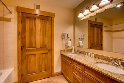 a bathroom with two sinks and a large mirror at 3 Bedroom Condo In River Run With Shared Pool, Hot Tubs, 100 Yards To Gondola in Keystone