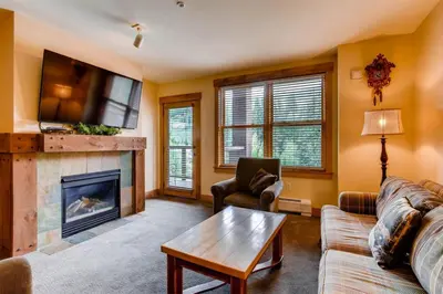 a living room with a fireplace and a tv at 3 Bedroom Condo In River Run With Shared Pool, Hot Tubs, 100 Yards To Gondola in Keystone