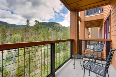 a balcony with a table and chairs and a view of the mountains at 3 Bedroom Condo In River Run With Shared Pool, Hot Tubs, 100 Yards To Gondola in Keystone