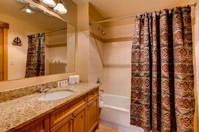 a bathroom with a sink and a shower curtain at 3 Bedroom Condo In River Run With Shared Pool, Hot Tubs, 100 Yards To Gondola in Keystone