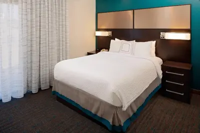 a large bed in a hotel room with white sheets at Residence Inn Denver Tech Center in Greenwood Village