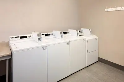 three washers and dryers sitting in a room at Residence Inn Denver Tech Center in Greenwood Village