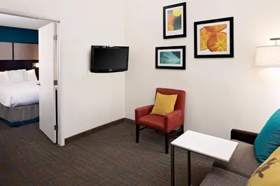 a hotel room with a bed and a chair and a tv at Residence Inn Denver Tech Center in Greenwood Village